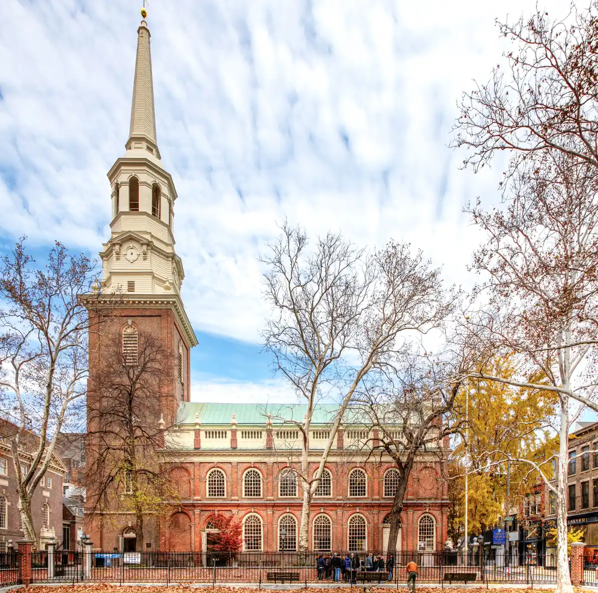 Christ Church in Philadelphia, a brick Georgian church with a white steeple, seen from the street.